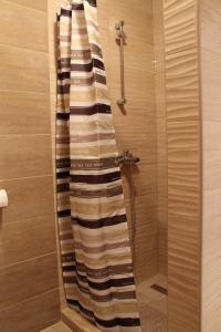 a shower with a glass door with towels in a bathroom at Apartment Podaca 15475d in Podaca