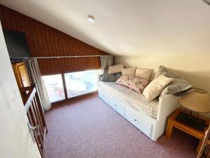 een slaapkamer met een wit bed met een raam bij Appartement 2 pièces avec mezzanine près des pistes - 6 personnes - FR-1-815-81 in Morillon +5 foto's