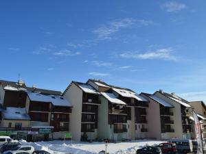 a row of apartment buildings with snow covered roofs at Studio Bolquère-Pyrénées 2000, 1 pièce, 4 personnes - FR-1-592-43 in Font-Romeu