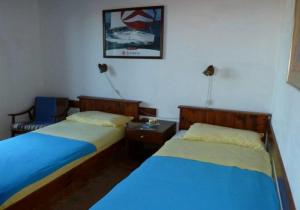 two beds in a room with two beds sidx sidx sidx at Apartments by the sea Kaprije - 15567 in Kaprije