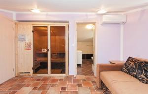 a living room with a couch and a glass door at Luxury villa with a swimming pool Supetarska Draga - Gonar, Rab - 15575 in Rab