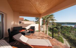 an outdoor patio with a view of the water at Luxury villa with a swimming pool Supetarska Draga - Gonar, Rab - 15575 in Rab