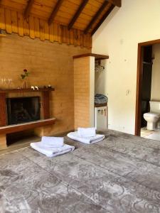 a room with a fireplace and two mattresses at Terrace house in Monte Verde
