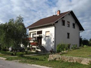 a white house with a black roof at Apartments with a parking space Delnice, Gorski kotar - 15589 in Delnice