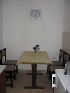 a table in a kitchen with a clock on the wall at Apartments with a parking space Delnice, Gorski kotar - 15589 in Delnice