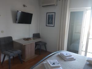 a bedroom with a bed and a desk and a television at Apartments by the sea Gradac, Makarska - 15642 in Gradac