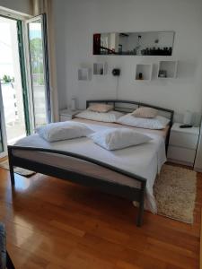 a bedroom with two beds and a large window at Studio Gradac 15642b in Gradac