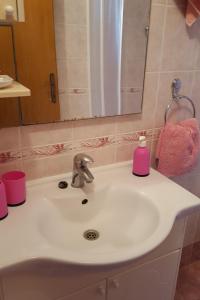 a bathroom sink with a pink soap dispenser on it at Studio Gradac 15642b in Gradac