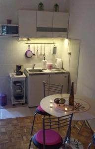 a small kitchen with a table and a table and chairs at Apartments with parking space Ugljan - 15613 in Ugljan +7 photos