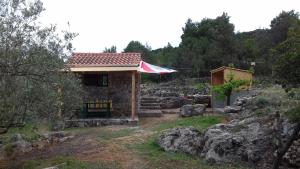 a small house with a flag on top of it at Secluded holiday house Pasman - 15649 in Pašman