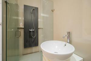 a bathroom with a sink and a shower at RedDoorz near Transmart Kalimalang in Jakarta