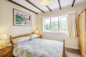 a bedroom with a bed and a window at Penlan in Beddgelert