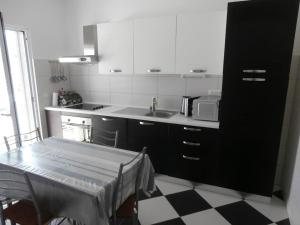 a kitchen with a table and a sink and a microwave at Apartment Sevid 15664a in Sevid