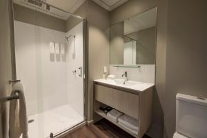 a bathroom with a sink and a shower at Quest 256 Lambton in Wellington