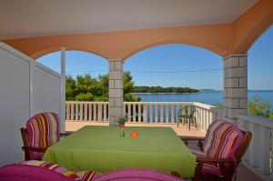 a dining room with a table and chairs on a balcony at Apartments by the sea Karbuni, Korcula - 15699 in Prizba