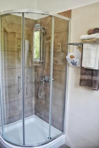 a shower with a glass door in a bathroom at Apartments with a parking space Smrika, Kraljevica - 15700 in Šmrika