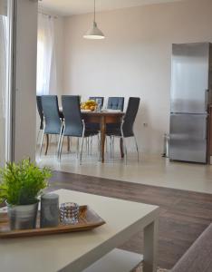 a kitchen and dining room with a table and chairs at Apartments with a parking space Smrika, Kraljevica - 15700 in Šmrika