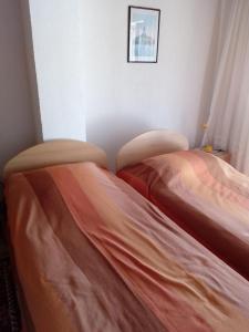 two beds sitting next to each other in a room at Apartments by the sea Sevid, Trogir - 15742 in Sevid