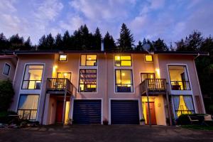 a large white building with lights on at The Twins in Queenstown