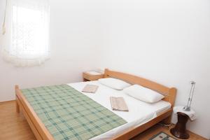 a bedroom with a bed with two pillows at Apartment Podaca 15748c in Podaca