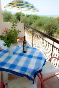 a bottle of wine sitting on a table on a balcony at Apartment Podaca 15748c in Podaca