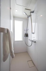een badkamer met een douche en een glazen deur bij urashima INN - GANGI - in Onomichi