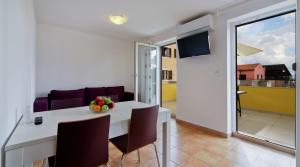a kitchen and living room with a table and chairs at Apartments by the sea Nerezine, Losinj - 15778 in Nerezine