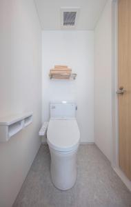 a bathroom with a white toilet in a room at urashima INN - GANGI - in Onomichi