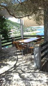 a table and chairs on a patio with a view of the ocean at Apartments by the sea Crnja Luka, Korcula - 15978 in Blato