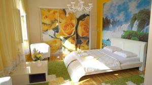 a bedroom with a white bed and a painting at Apartments with WiFi Pula - 15986 in Pula