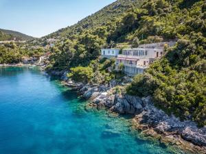 an aerial view of a river with houses on a hill at Apartments by the sea Sobra, Mljet - 15993 in Babino Polje