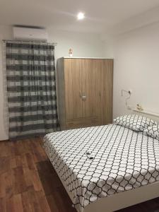 a bedroom with a bed and a wooden cabinet at Apartments with a parking space Podstrana, Split - 16032 in Podstrana