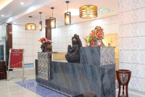 a lobby with a counter with sculptures on it at MR River Resort in Rishīkesh