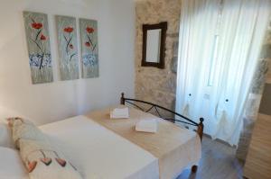 a bedroom with a bed and a window at Holiday house with a parking space Skrbcici, Krk - 16084 in Vrh