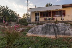 a house with a large rock in front of it at Apartments with parking space Kastel Stafilic, Kastela - 16086 in Kaštela +7 photos
