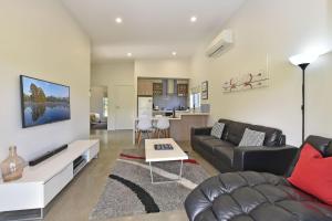 a living room with a couch and a table at Ironbark Hill Villa 2 Aneis in Pokolbin