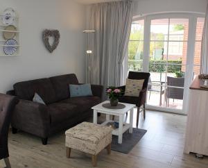 a living room with a couch and a table at Hannes Koje in Greetsiel