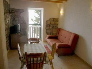a living room with a couch and a table at Apartments by the sea Brist, Makarska - 16098 in Podaca