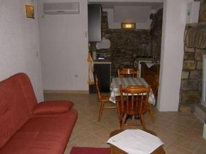 a living room with a couch and a table and chairs at Apartments by the sea Brist, Makarska - 16098 in Podaca