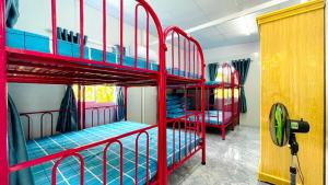 a room with two red bunk beds in it at Thanh Nhi Homestay in Cam Ranh