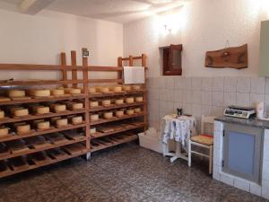a kitchen with lots of shelves of cheese at Studio Pag 16100a in Pag