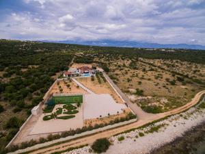 an aerial view of a house with a basketball court at Seaside luxury villa with a swimming pool Cove Mihovilje, Pag - 16124 in Novalja