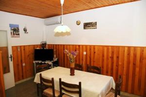 a dining room table with a vase of flowers on it at Apartments by the sea Prigradica, Korcula - 16125 in Blato