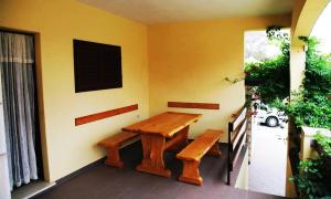 a wooden bench sitting on the side of a house at Apartments by the sea Prigradica, Korcula - 16125 in Blato