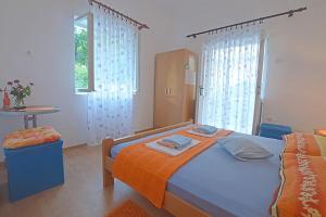 una camera con letto, tavolo e finestre di Apartments and rooms by the sea Podaca, Makarska - 16160 a Podaca
