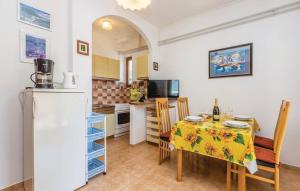 a kitchen with a table with a yellow table cloth at Apartments with a parking space Cres - 16178 in Cres