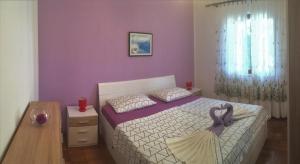a small bedroom with a bed and a table at Apartments with a parking space Cres - 16178 in Cres