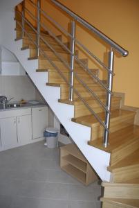 een trap met houten en metalen relingen in een keuken bij Apartments with a parking space Senj - 15376 in Senj