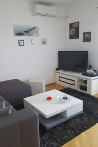 a living room with a couch and a coffee table at Apartments by the sea Ploce, Neretva Delta - Usce Neretve - 16195 in Ploče