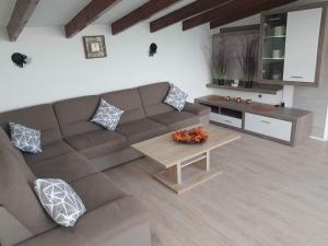 a living room with a couch and a coffee table at Family friendly house with a swimming pool Kastel Novi, Kastela - 16199 in Kastel Novi